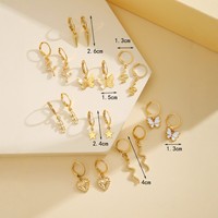 Nouvel ensemble de 9 boucles d'oreilles minimalistes de style européen en alliage plaqué or, avec étoile à cinq branches, papillon et cœur, et chaîne serpent