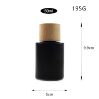 Emballage de bouteille de parfum de jet de cylindre du noir mat 50ml de style simple de luxe avec le couvercle et la boîte