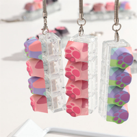 Porte-clés pendentif patte de chat colorée et mignonne, jouet anti-stress imprimé patte de chat, clavier à boutons pour sac à dos