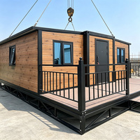 Maison préfabriquée en conteneur avec terrasse en métal noir, résistante à l'humidité, détachable, 2 chambres, maison préfabriquée de loisirs en plein air