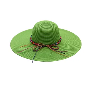 Moda UPF50 Summer Beach Sun Hat Logotipo personalizado Cuerda de papel Decoración de cuentas de madera Ala ancha Trenza Floppy Sombreros de paja para mujeres