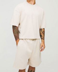 เสื้อยืดทรงบ็อกซี่โอเวอร์ไซส์ผ้าคอตตอน 100% พร้อมกางเกงขาสั้นทรงดรอปครอช ชุดเซ็ตแทรคสูทสำหรับผู้ชาย - Product Image 1