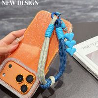 Cordon de téléphone tressé color block court anti-perte avec pendentif cœur, breloque de téléphone personnalisée très tendance