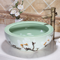Fregaderos de baño de cerámica de flor de ciruelo redondo pintado a mano con arte sobre encimera verde esmaltado a la venta