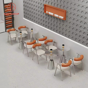 Set di Arredamento Commerciale per Ristoranti: Divano a L in Pelle Bianca per Caffetteria, Tavoli Rotondi in Metallo e Sedie Arancioni per Bar - Product Image 2