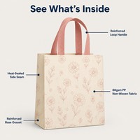 Sac cadeau non tissé en gros, écologique et réutilisable, imprimé floral avec poignées roses pour l'emballage de cadeaux de détail