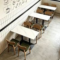 Ensemble de salle à manger moderne et minimaliste en cuir PU avec plateau en pierre et structure en métal pour restaurants et cafés