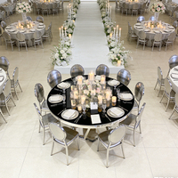 Table de salle à manger ronde de luxe avec plateau en verre noir, base géométrique argentée et structure en acier inoxydable
