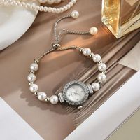 Montre-bracelet élégante pour femme, réglable, romantique, avec perles blanches, à cordon, mouvement à quartz, cadran orné de strass (WA386)