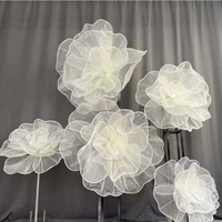Arrangements floraux géants en organza blanc sur mesure, luxueux et haut de gamme, pour décorations de mariage et vitrines.
