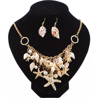 Collier, bracelet et boucles d'oreilles unisexes plaqués or, style bohème chic, avec breloques en forme de coquillage, étoile de mer et conque, pour la vente en gros