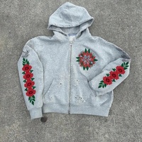 Ensemble de survêtement deux pièces OEM assorti, sweat à capuche zippé et pantalon de survêtement, motif floral large, effet déchiré et ourlet brut