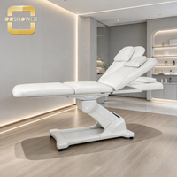 Table de massage électrique blanche avec rembourrage épais en PU, moteur silencieux et base stable pour les cliniques de médecine esthétique et les instituts de beauté