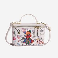 Nouveau sac seau fourre-tout à fermeture éclair pour filles, imprimé ours en peluche et graffiti, sac à bandoulière polyvalent au design de niche, sac cosmétique à porter en travers du corps