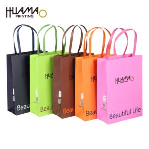 Sacs en papier multicolores Huamao, attrayants et avec poignée, commande en gros pour vêtements, cosmétiques et emballages cadeaux - Product Image 1