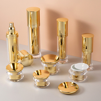 Pot et bouteille de crème pour le visage en plastique acrylique cosmétique doré de luxe personnalisé pour ensemble d'emballage de soins de la peau
