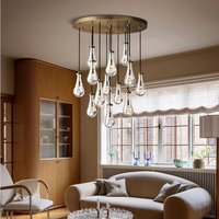 Lustre moderne de luxe en laiton doré, suspension décorative LED en verre en forme de goutte de pluie pour entrée à plafond haut