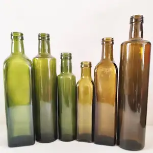 موزع زيت زجاجي وخلفية مع زجاجة زيت للمطبخ من الفولاذ المقاوم للصدأ زجاجة زيت زيتون خضراء داكنة 500 مل