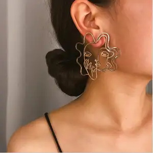 wholesale 2019 trendy gold hollow alloy stud earrings exaggerated girl's face statement earrings for women