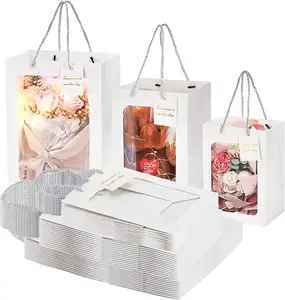 白色礼品袋，配有透明窗户和把手、花束包装、购物伴侣手袋和定制图案