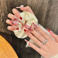 Diseño #2493 Proveedor de uñas al por mayor 10 piezas Diseños de lujo Lazo Rojo Cubierta completa Falso hecho a mano Año Nuevo Prensa en las uñas