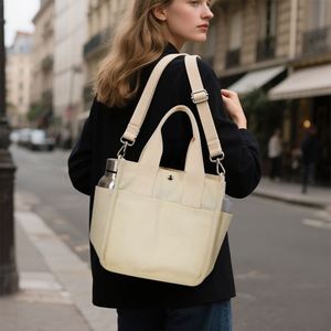 Sac fourre-tout en toile beige avec poches latérales pour bouteille d'eau et bouton-pression pour le bureau, les pique-niques et le transport de repas bento - Product Image 2