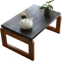 Table basse en bois massif de style zen japonais avec plateau teinté au charbon et base en bois naturel