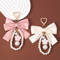 Porte-clés élégant avec nœud en perles, pendentif décoratif pour sac à main pour filles