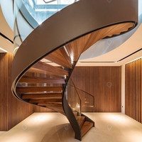 Design d'escalier courbé grandiose avec structure en acier carbone massif et garde-corps en verre transparent pour villa haut de gamme