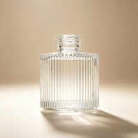Nouvelle bouteille de parfum en verre ronde unique de 100 ml, diffuseur d'arômes cylindrique en verre avec logo personnalisé