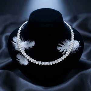 Collier tennis classique avec cristaux ovales sur support en velours, décoration plume blanche, fond élégant - Product Image 1