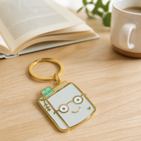 Porte-clés en émail, pendentif livre mignon de dessin animé, breloque visage, accessoires de sac à dos en métal doré, cadeau, marque-page 'READ', vente en gros