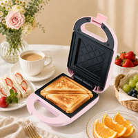 Machine à sandwich électrique compacte rose résistante à la chaleur avec double plaque, poignée verrouillable et voyant lumineux pour la cuisine domestique
