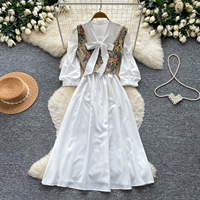 Ensemble élégant vintage 2 pièces pour femme : Robe gilet et jupe mi-longue taille haute à col noué et manches bouffantes, idéal pour les trajets quotidiens en automne