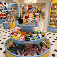 Présentoir d'îlot incurvé personnalisé bleu-jaune avec vitrine en verre pour magasin de jouets et peluches