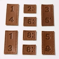 Etiquettes personnalisées en rouleau en cuir à coudre avec logo en relief pour vêtements, vêtements, jeans