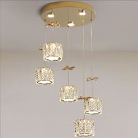 Lustre suspendu moderne de luxe en acier inoxydable avec plusieurs têtes cylindriques, fleurs en cristal doré, pour bar et salle à manger
