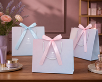 Sacs cadeaux en papier pastel avec nœuds en ruban et poignées en corde, dégradé rose et bleu, pour mariages, baby showers et anniversaires