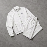 Survêtement blanc personnalisé OEM à marque privée, respirant, avec fentes latérales, fermeture métallique, col montant, pantalon de jogging, fabricant designer