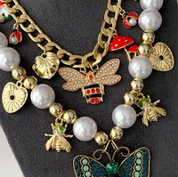 Collier multi-pendentifs papillon vert tendance 2025 avec perles et chaînes superposables