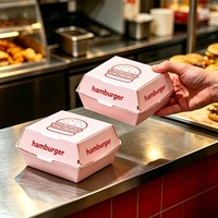 Kartonnen hamburgerdozen in lichtroze kleur met burger-schetslogo, wegwerpbaar, food grade, voor afhaalmaaltijden, fastfoodverpakkingen
