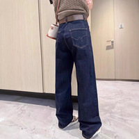 Jeans taille haute pour femme, bleu foncé délavé, coupe incurvée, style urbain, design oversize, ourlet effiloché, vente en gros usine