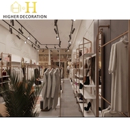 Vitrine de magasin de vêtements moderne, présentoir de vêtements en métal de luxe, présentoir de vêtements personnalisé, mobilier de magasin de vêtements durable