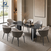 Ensemble de table à manger de luxe avec 6 chaises, plateau en marbre noir, base en acier foncé en forme de V, fauteuils en tissu PU, style Japandi, villa, vente en gros, usine OEM