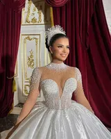Robe de mariée de luxe à col montant, transparente, ornée de perles, à manches longues, style robe de bal