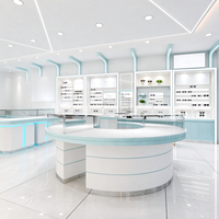 Vitrine de magasin d'optique en verre blanc avec pieds en tube doré, barre lumineuse et protection en verre, certifiée CE ETL pour opticien