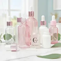 Flacons cosmétiques vides en verre cylindrique rose doré de 30 ml et rose translucide de 50 ml avec impression sérigraphique