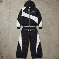 Ensemble décontracté deux pièces pour homme, haut à manches longues zippé noir et blanc avec blocs de couleur et pantalon à cordon de serrage, OEM ODM