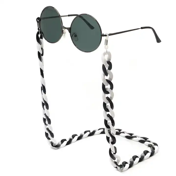 designer Sunglasses chain: round Beads of Naga Eyes Stone with realistic 4k  and soft lighting. low angle. on texture luxury background. product shot