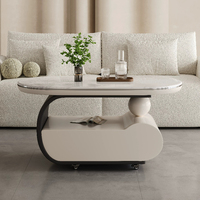 Table basse mobile incurvée en crème, surface en pierre microcristalline, base de rangement avec roulettes silencieuses, bureau minimaliste pour salon